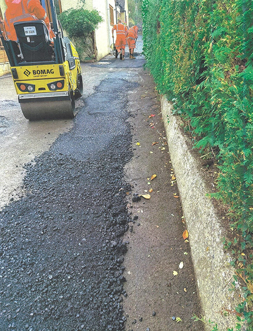 Remove old surface, apply tack coat / regulate low areas